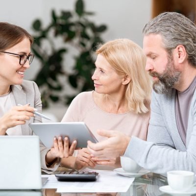 mature-couple-listening-to-agent-making-presentati-ZSFXB8N.jpg